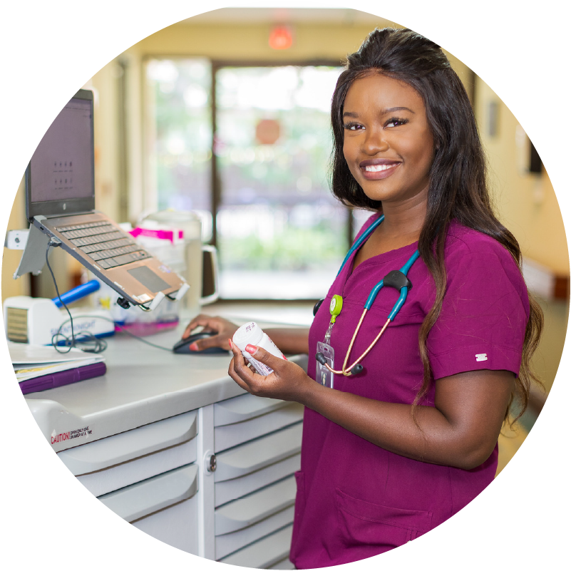 Female nurse smiles at camera